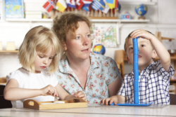 teacher teaching two child